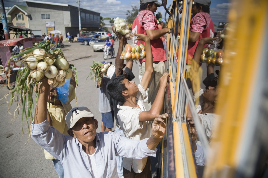 Sebaco, Nicaragua Vegetable vendors rush a yellow school bus at the Sebaco stop on the route from Managua to Matagalpa.